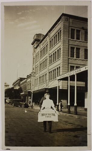 Photograph - Street Scene Featuring Man Holding Hecla Electrics Pty Ltd Advertisment, circa 1920s