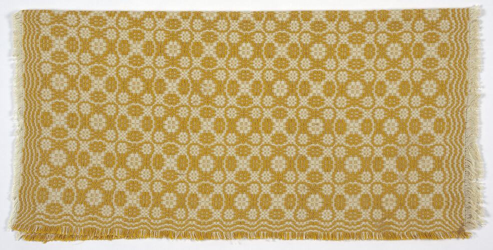 Fabric with cream background and gold circle pattern.