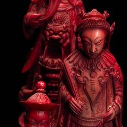 Three red Royal Chinese ivory chess pieces.