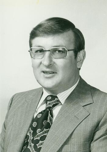 Portrait of a man wearing a pinstripe suit.