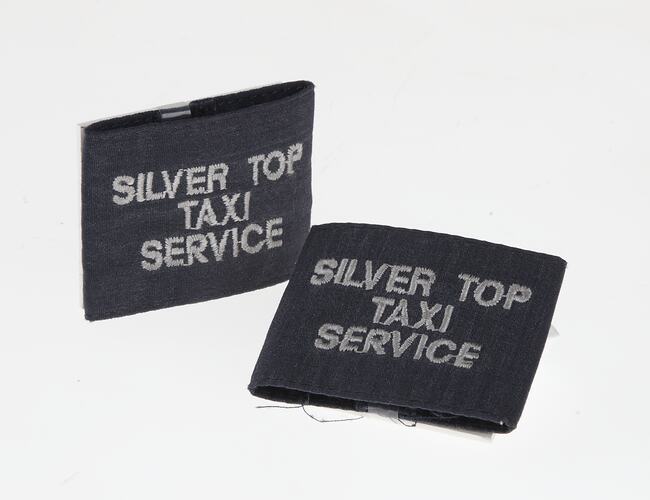 Dark cloth square sections with white embroidered lettering.