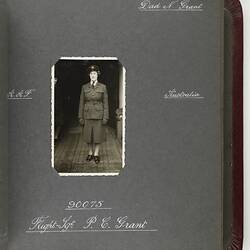 Dark page with handwritten white text and photograph of servicewoman in centre.