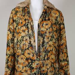 Yellow and green floral silk jacket with fur collar.