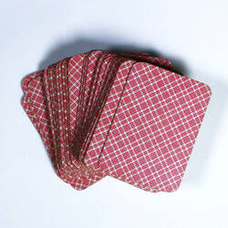 Pack cards spread out, with checked red back.