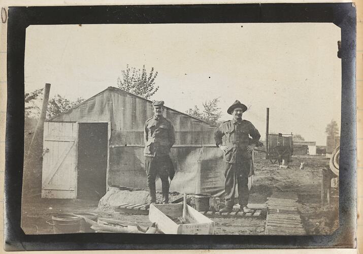 Two soldiers standing in front of a tent
