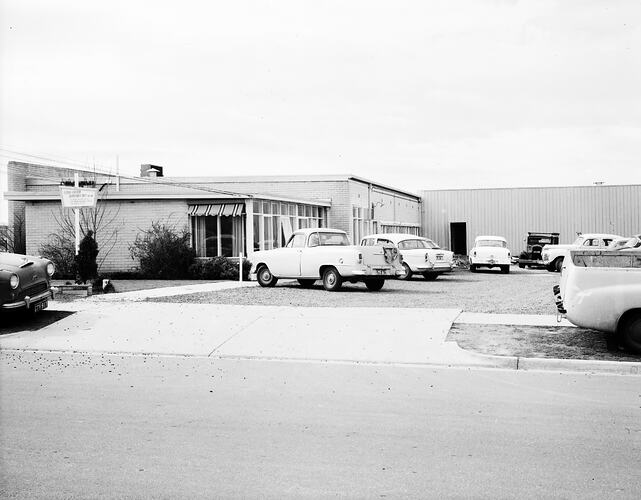 Monochrome image of a factory exterior.