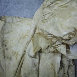 Cream dress showing stained underarm detail.