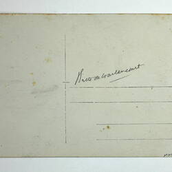 Back of photo showing postcard proforma and hand-writing.