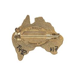 Back of metal badge with pin.