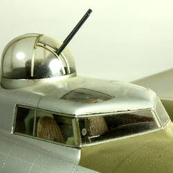Silver model aeroplane. Detail of cockpit and bubble canopy.