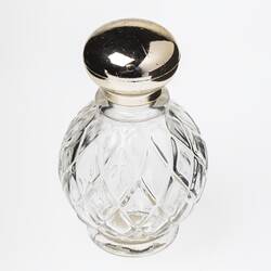 Clear round glass perfume bottle, diamond faceting. Plastic gold screw lid.