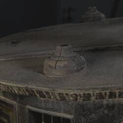 Black wooden hearse, detail of decorative woodwork. Base where urn once was.