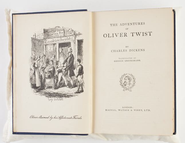 Open book with printed illustration of mid 19th century town scene.