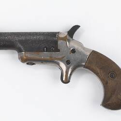 Pistol, metal with wooden grip.
