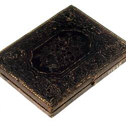 Closed black photograph frame. Made of embossed decorative leather.