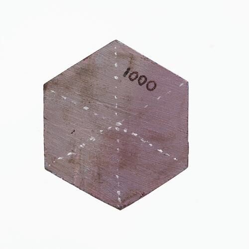 Hexagonal wooden crystal model painted mauve and white.