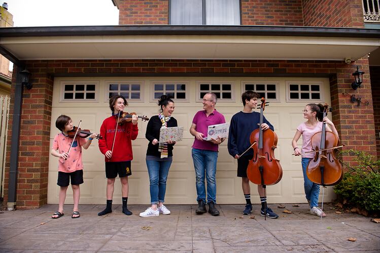 Family standing in their front yard with musical instruments during COVID-19 lockdowns, Fairfield, 7 May 2020