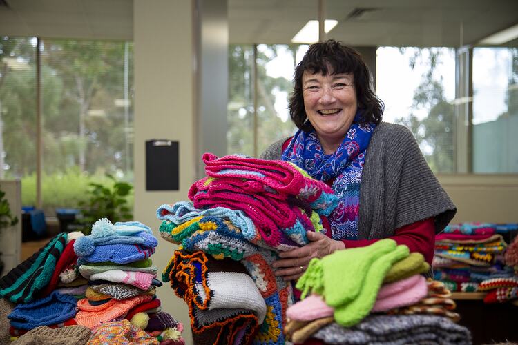 Maroondah City Council Staff Member Holding Knitted Garments for Charity during COVID-19, Victoria, 22 Jul 2020