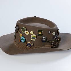 Akubra hat covered in different badges.