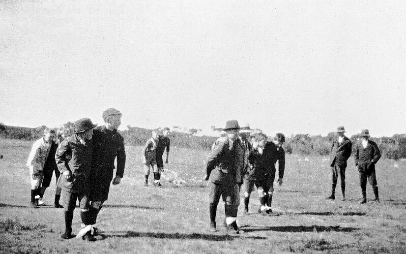 Young school boys during three legged race.