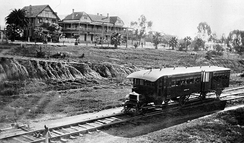 [Rail motor travelling past the Grand Hotel, Mildura, circa 1930.]