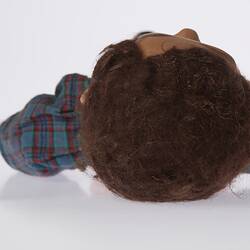 Top view of doll's head with brown hair.