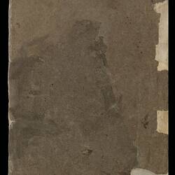 Back cover of an worn and torn unbound book of folded paper leaves.