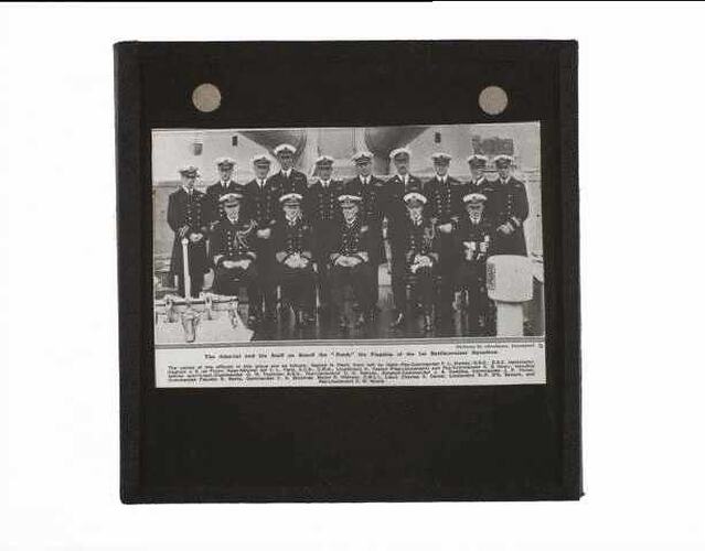 Naval officers posed on deck of warship.