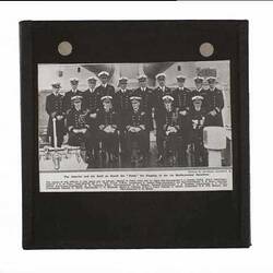 Naval officers posed on deck of warship.