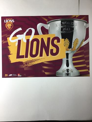Maroon poster with printed white and maroon text on yellow and silver trophy cup.