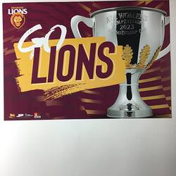 Maroon poster with printed white and maroon text on yellow and silver trophy cup.