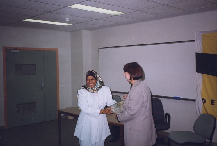 Woman being presented with a certificate.