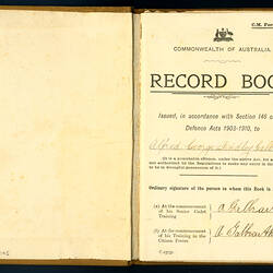 Cover page of open book, with printed and handwritten text.