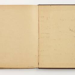 Open book with off white ruled pages.
