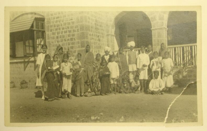 Posed group of Indian men, women and children.
