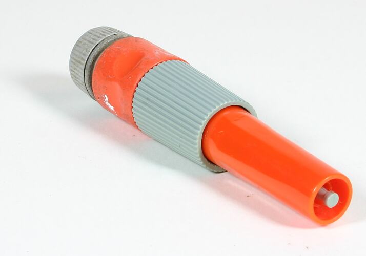 Orange and grey plastic hose attachment.