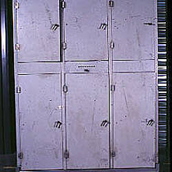 Rear view grey, metal six-doored cabinet.