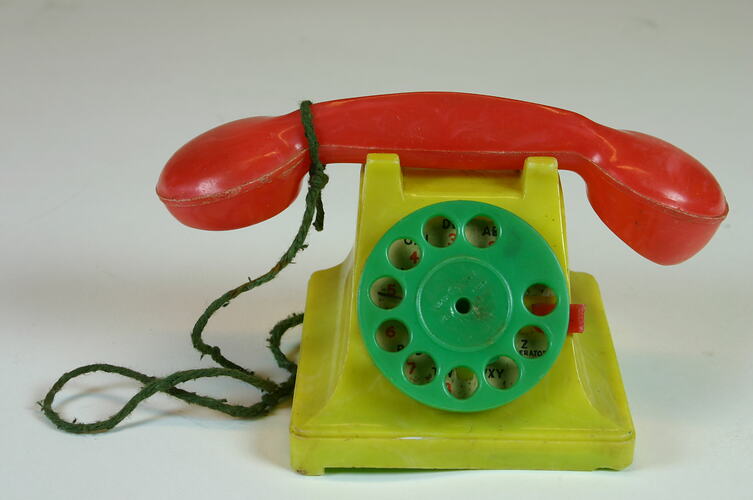 Side view of plastic toy telephone.