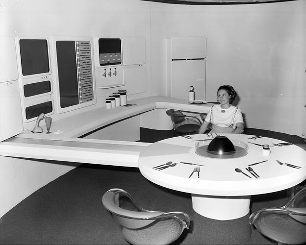Woman seated at a dinning table, Futuristic living room display