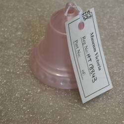 Small pink plastic bell