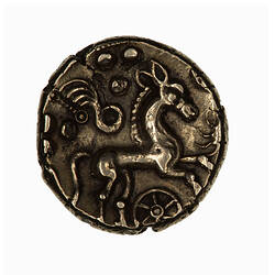 Coin, round, horse to the right with a spoked wheel below and curved object above together with pellets.