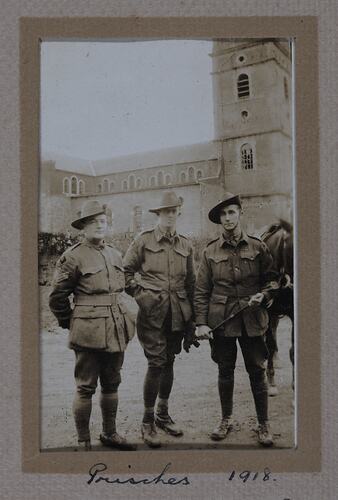 Three men in military uniform.
