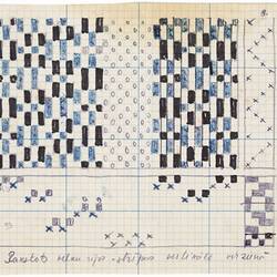 White sheet with black and blue square gridded pattern. Crosses marked along right edge and along bottom.