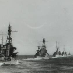 Six ships in a line formation in the ocean.