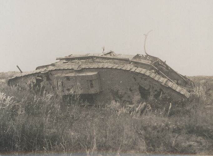 Derelict British tank in field.