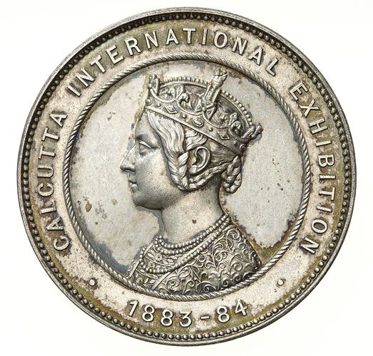Round medal with Queen Victoria profile bust in Empress of India style. Text around edge.