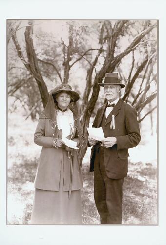 Man and woman, posed with trees behind.
