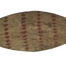 Broad wooden shield with diamond pattern.