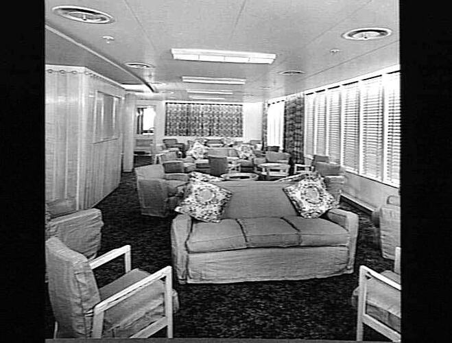 Ship interior. Lounge room with couches and cushioned chairs.