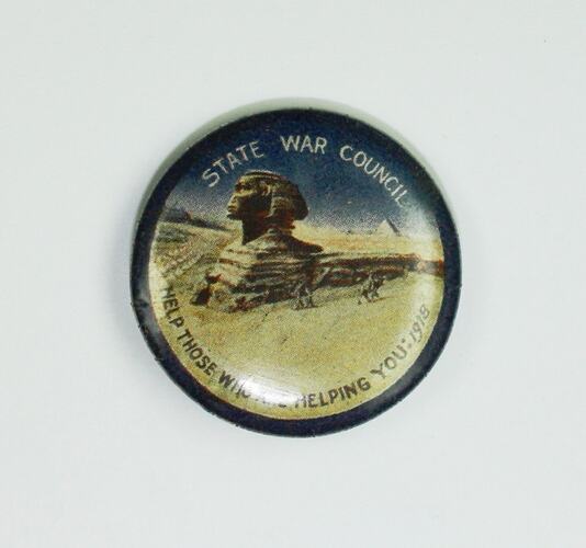 Badge with scene of Sphinx in desert.